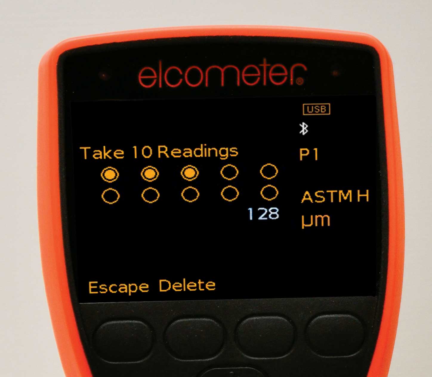 The face of an elcometer coating inspection LED screen. On the screen, there is the copy 'Take 10 Readings' and 10 circles underneath. In the bottom left corner, there are the options to 'Escape' and 'Delete.' Under the LED screen are four buttons.