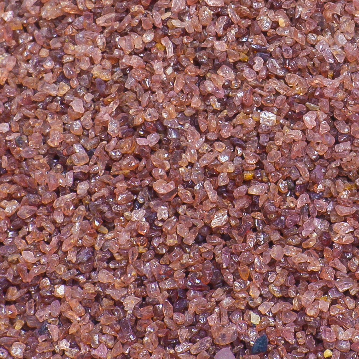 A mix of small, red shiny minerals